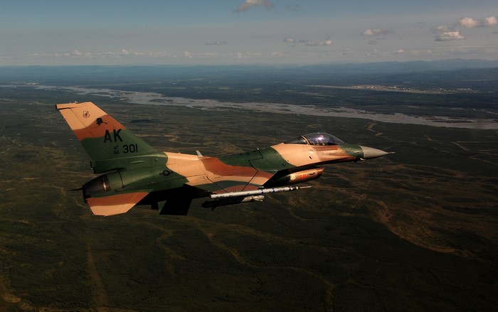 F-16C Fighting Falcon in flight over landscape