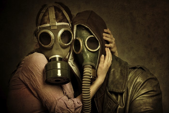 Couple in love wearing gas masks