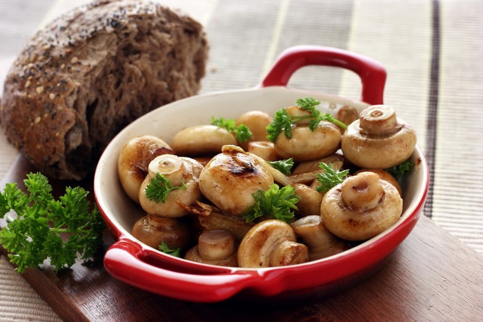 Mushrooms in a red dish with bread