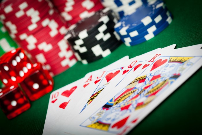Playing cards and casino chips on a green felt table