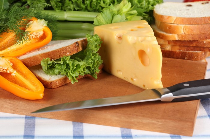 Cheese, Bread, Bell Pepper, and Knife on Cutting Board