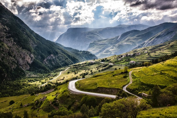 Winding road through green mountains in France