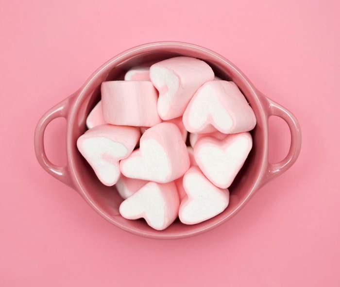 Pink heart-shaped marshmallows in a pink bowl