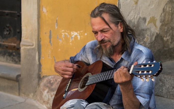 Man playing a guitar outdoors