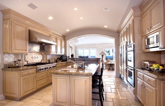 Kitchen with island and archway to living room