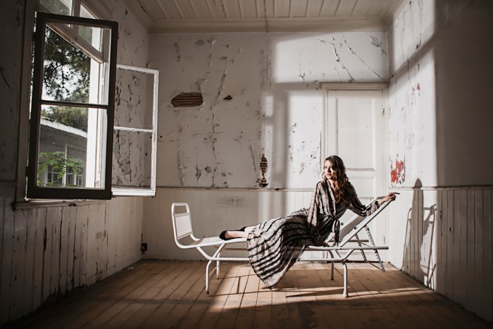 Woman on a sunlounger in an abandoned room