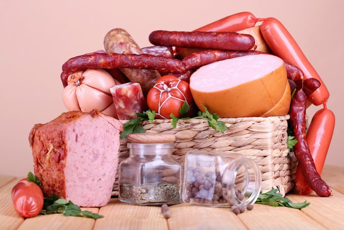 Meat products and sausages in a wicker basket