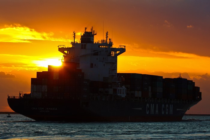 Container ship CMA CGM JAMAICA at sunset