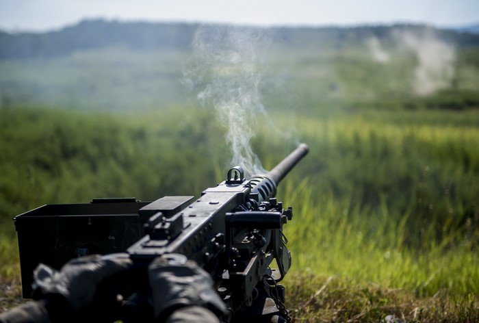 M2 Browning machine gun firing with smoke