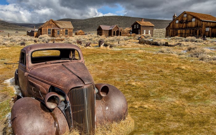 Rusty vintage car in abandoned ghost town