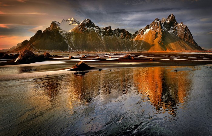 Mountains reflecting in a tidal flat at sunset