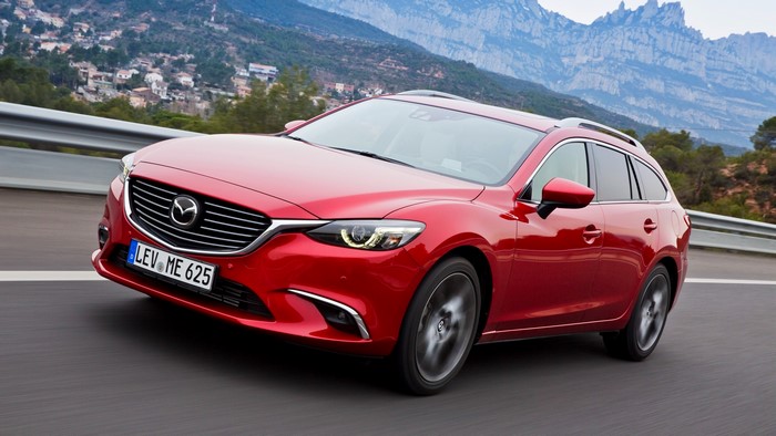 Red Mazda 6 Wagon driving on a road