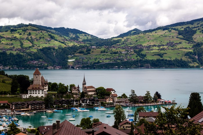 Castle and village on a lake in Switzerland with mountains