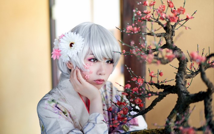 Woman in Kimono with Flowers and Bonsai Tree