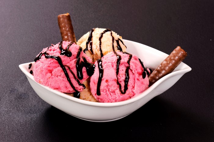 Ice cream sundae with chocolate syrup and wafer sticks