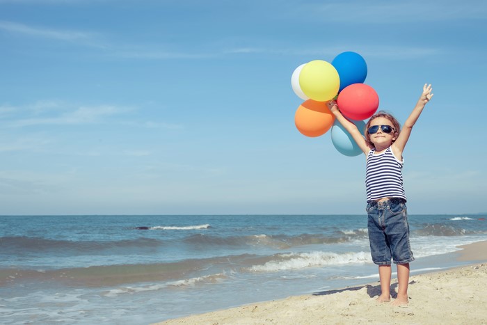 Girl with Balloons on the Beach