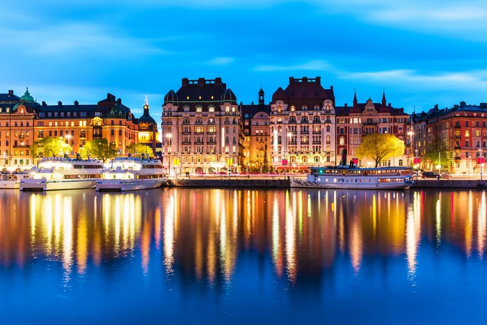 Stockholm waterfront with buildings and boats at night