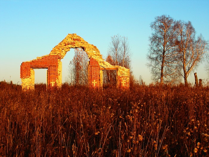 Ruins of a brick building in a field