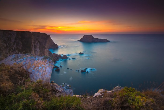 Sunset over rocky coast and sea