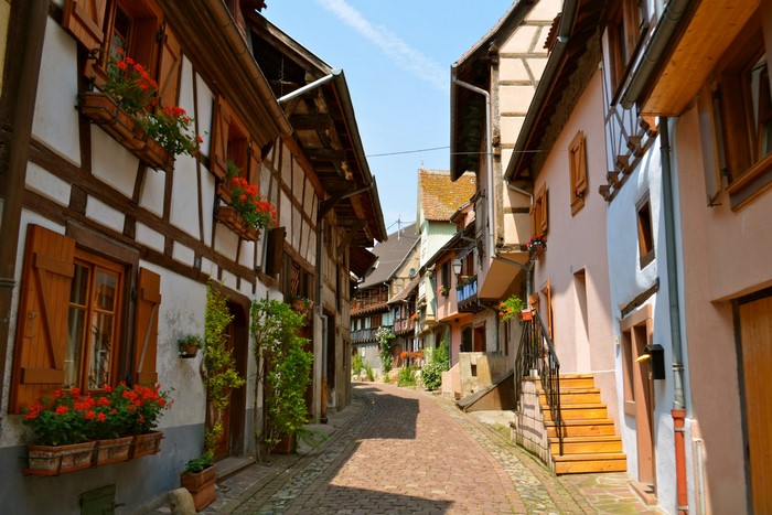Half-timbered houses on a cobblestone street in Eguisheim, France