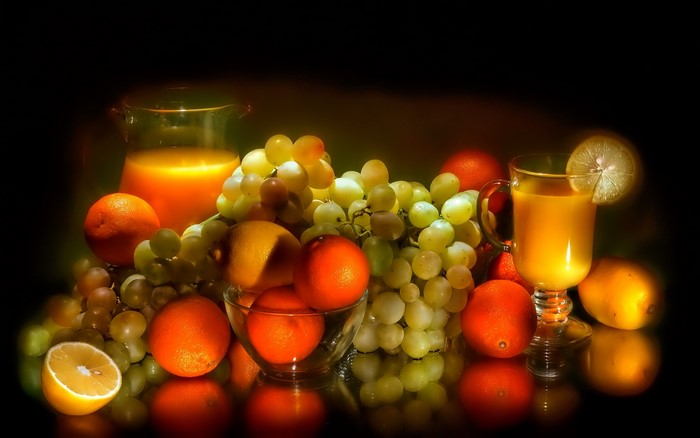 Still life with juice, grapes, oranges, and lemons