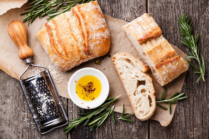 Bread, Olive Oil, Rosemary, and Grater Still Life