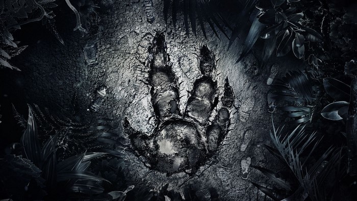 Dinosaur footprint on cracked ground with plants