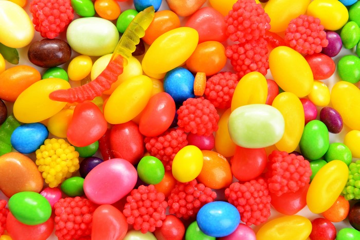 Assortment of colorful candies and gummy worm