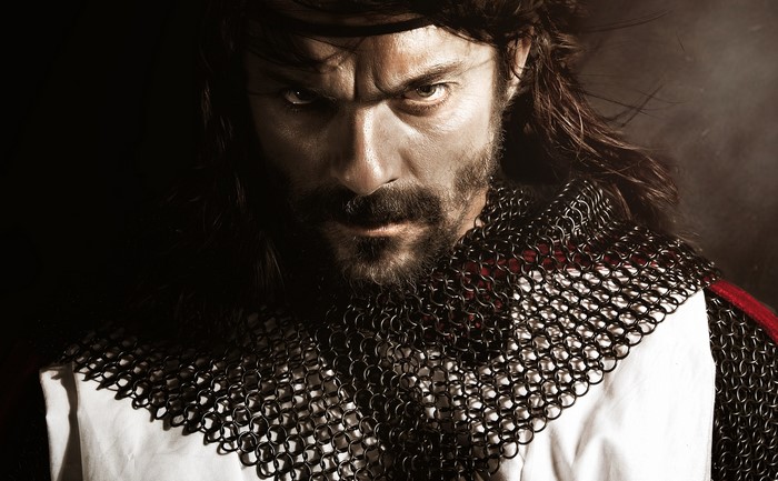 Man in chainmail armor with beard and mustache