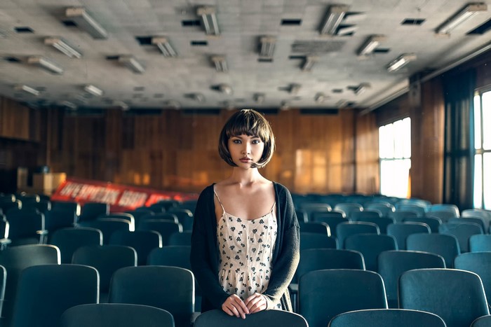 Woman in empty auditorium