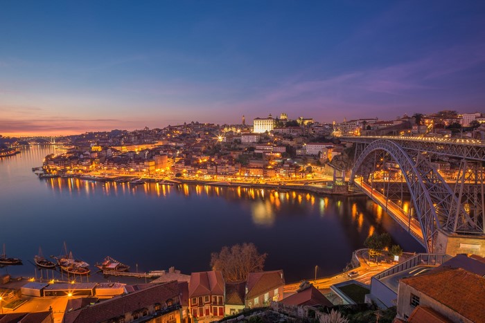 Porto cityscape with Dom Luís I Bridge over the Douro River at dusk