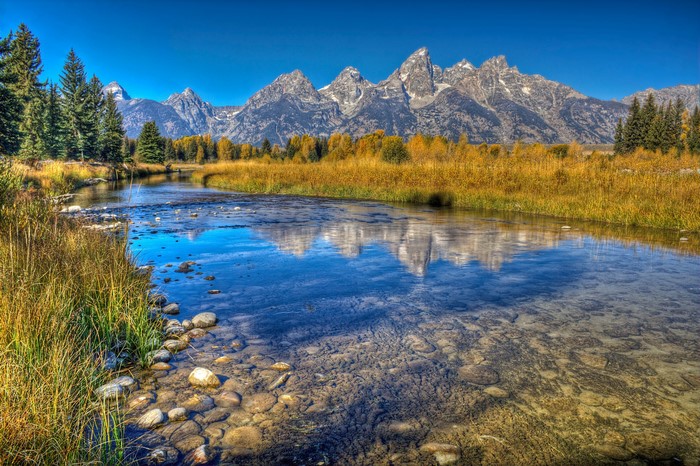 Grand Teton Mountains reflected in a river
