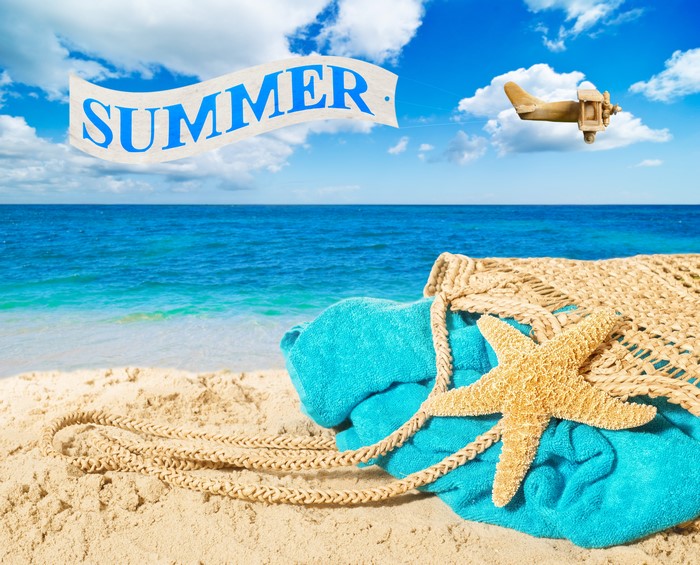 Summer beach scene with starfish and airplane