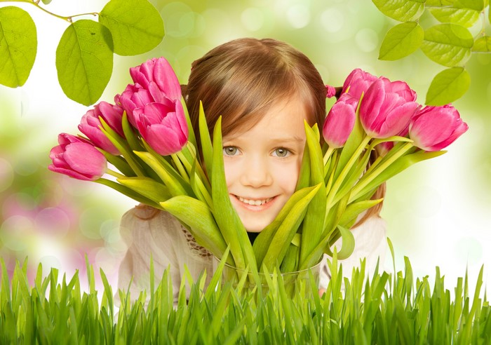 Girl with pink tulips and grass