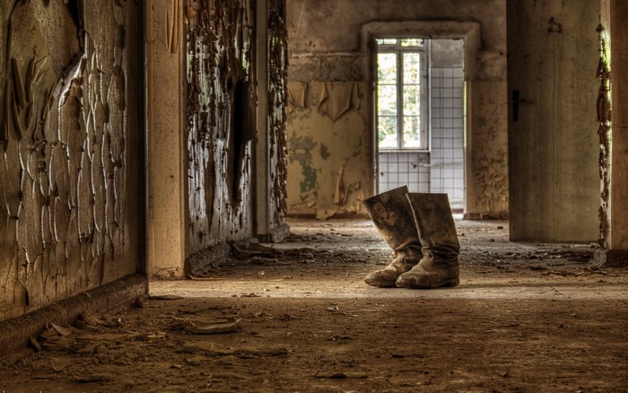 Old hallway with worn boots
