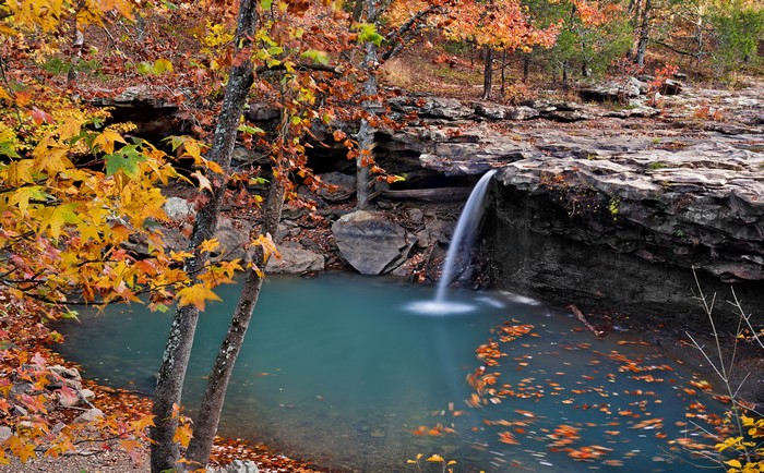 Waterfall in autumn forest with colorful leaves
