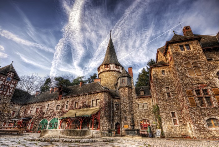Castle with a conical tower and ivy-covered walls