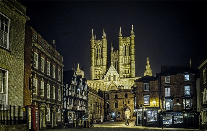 Lincoln Cathedral at night with historic buildings
