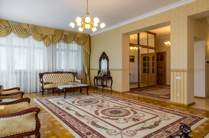 Living room with chandelier, sofa, and carpet