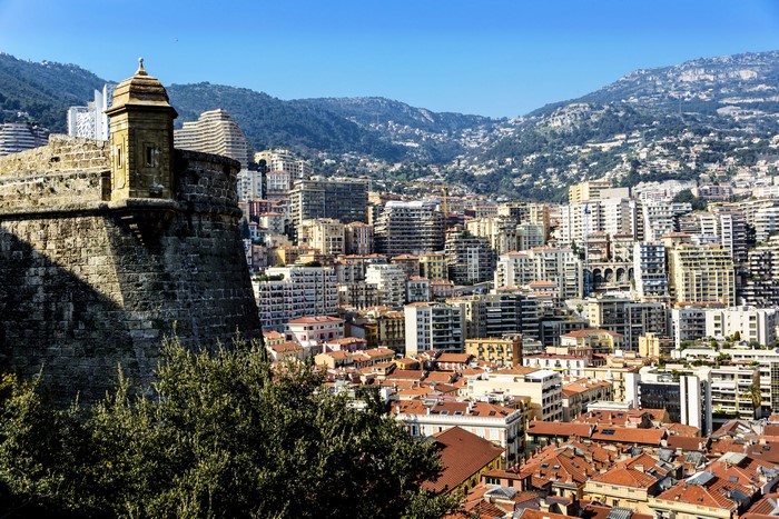 4K Monaco cityscape with mountains and fortress