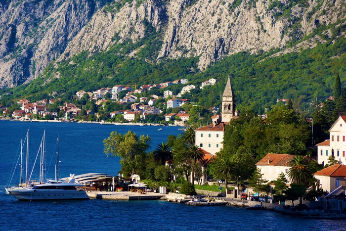 Bay with yachts and town at the foot of mountains in Montenegro