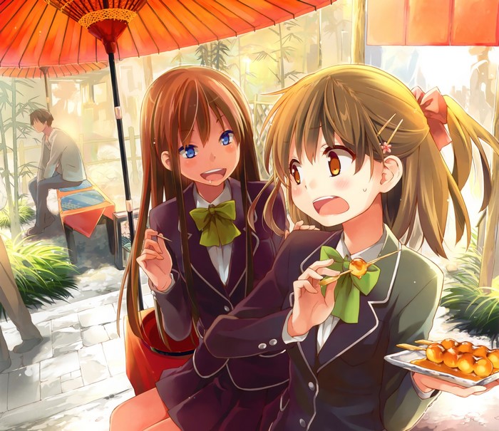 Two schoolgirls eating dango under an umbrella