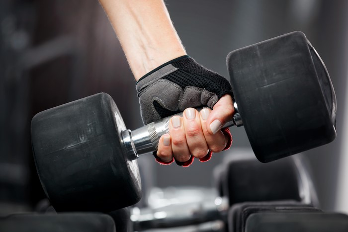 Hand in weight glove holding a dumbbell
