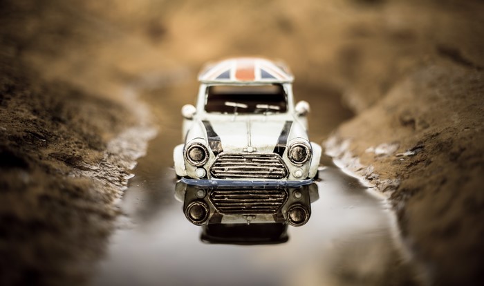 Toy Mini Car with Union Jack Roof in Puddle