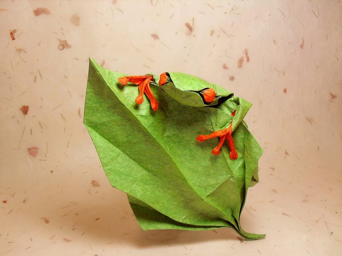 Origami frog on a green leaf