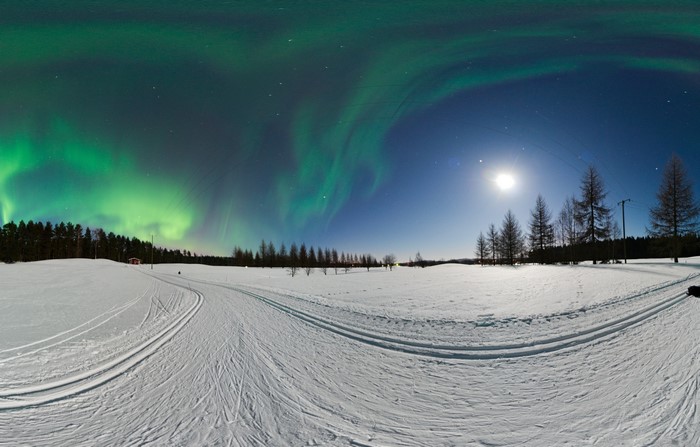 Aurora Borealis over Snowy Landscape with Moon