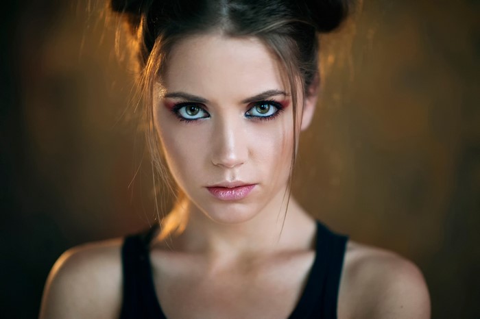 Woman with dramatic makeup and hair buns