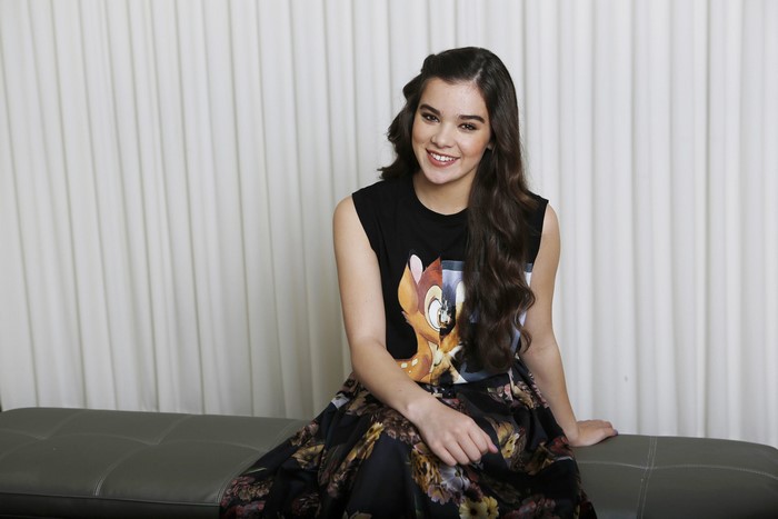 Hailee Steinfeld sitting on a bench