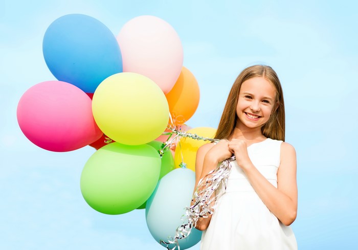 Girl holding colorful balloons