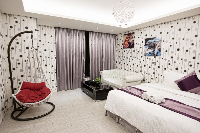 Bedroom with armchair, bed, and sofa